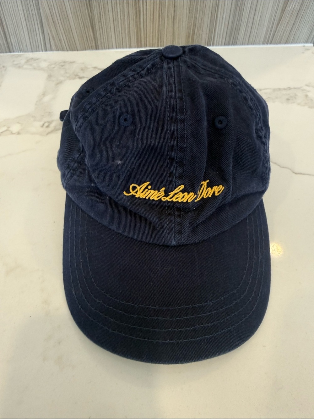 Aimé Leon Dore Washed Script Hat – Navy with Yellow Embroidery